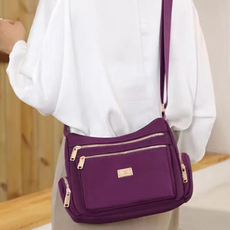 Women's handbag in various colors, multi-layered with zippers, can be worn diagonally or carried on the shoulder.